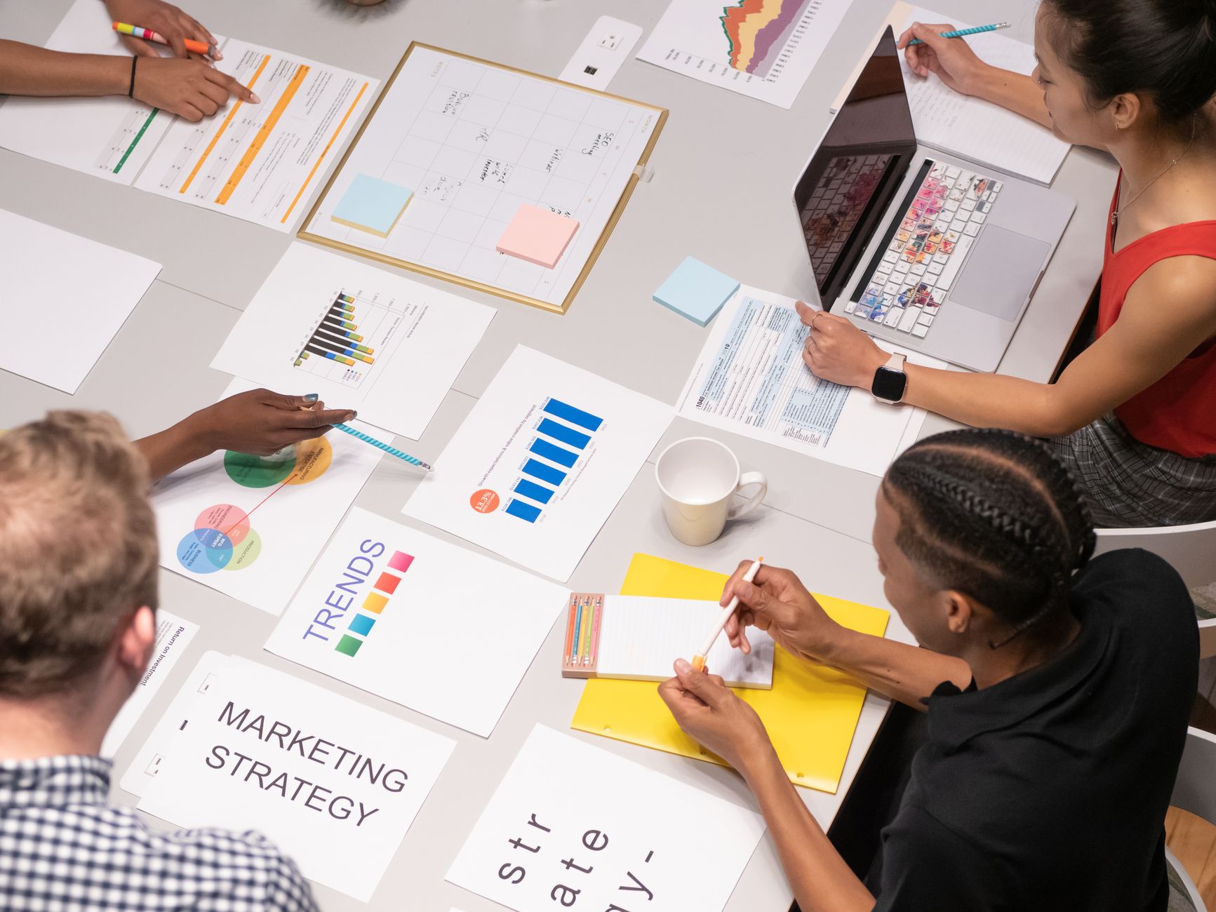 Brand strategy team reviewing competitive market intelligence data and positioning benchmarks